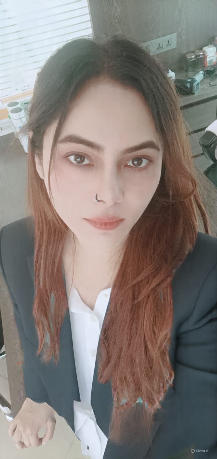 Portrait of Vibha Jain, hypnotherapist, wearing a dark blazer over a white shirt.
